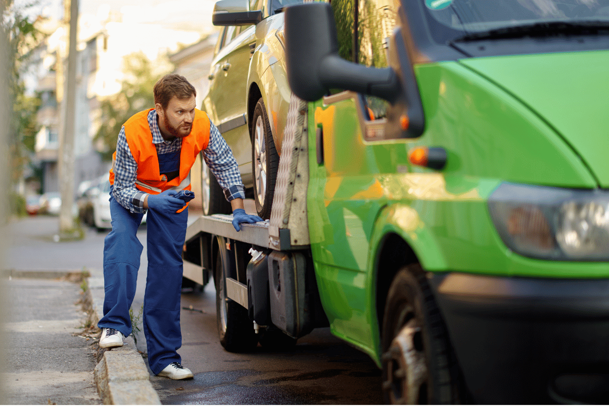 person checking car before towing