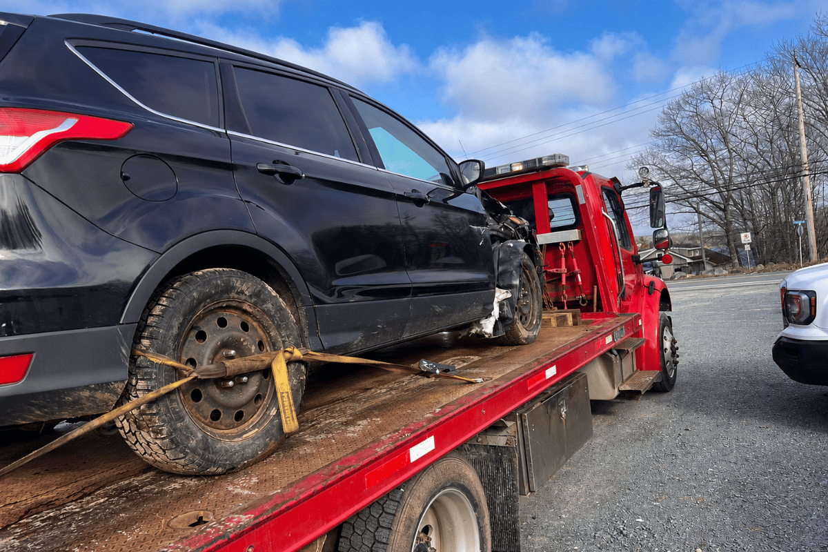 tow truck helping broken down car